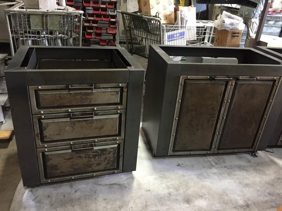 Fabricated cabinets with metal frames, doors, and drawers.