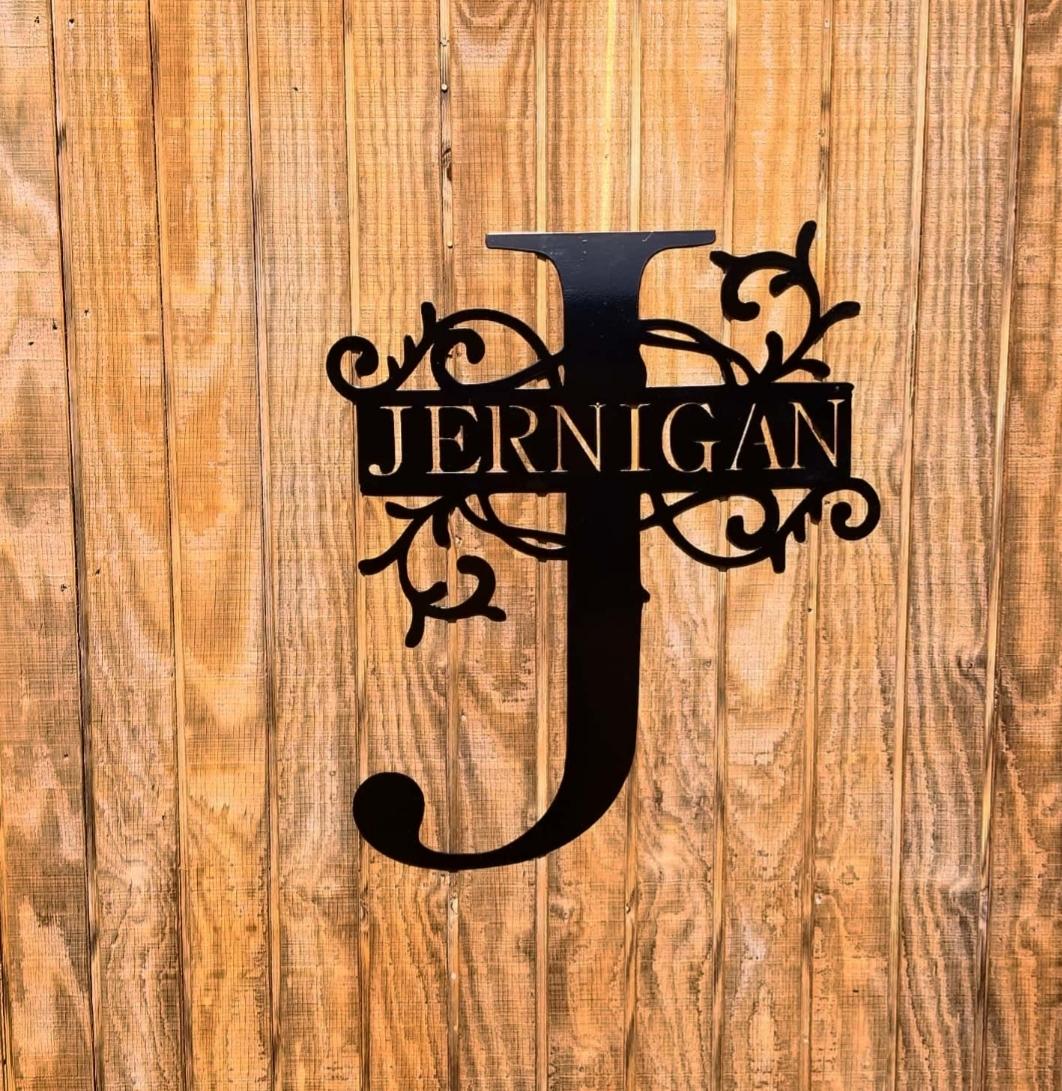 Decorative Jernigan monogram displayed on a wood background.