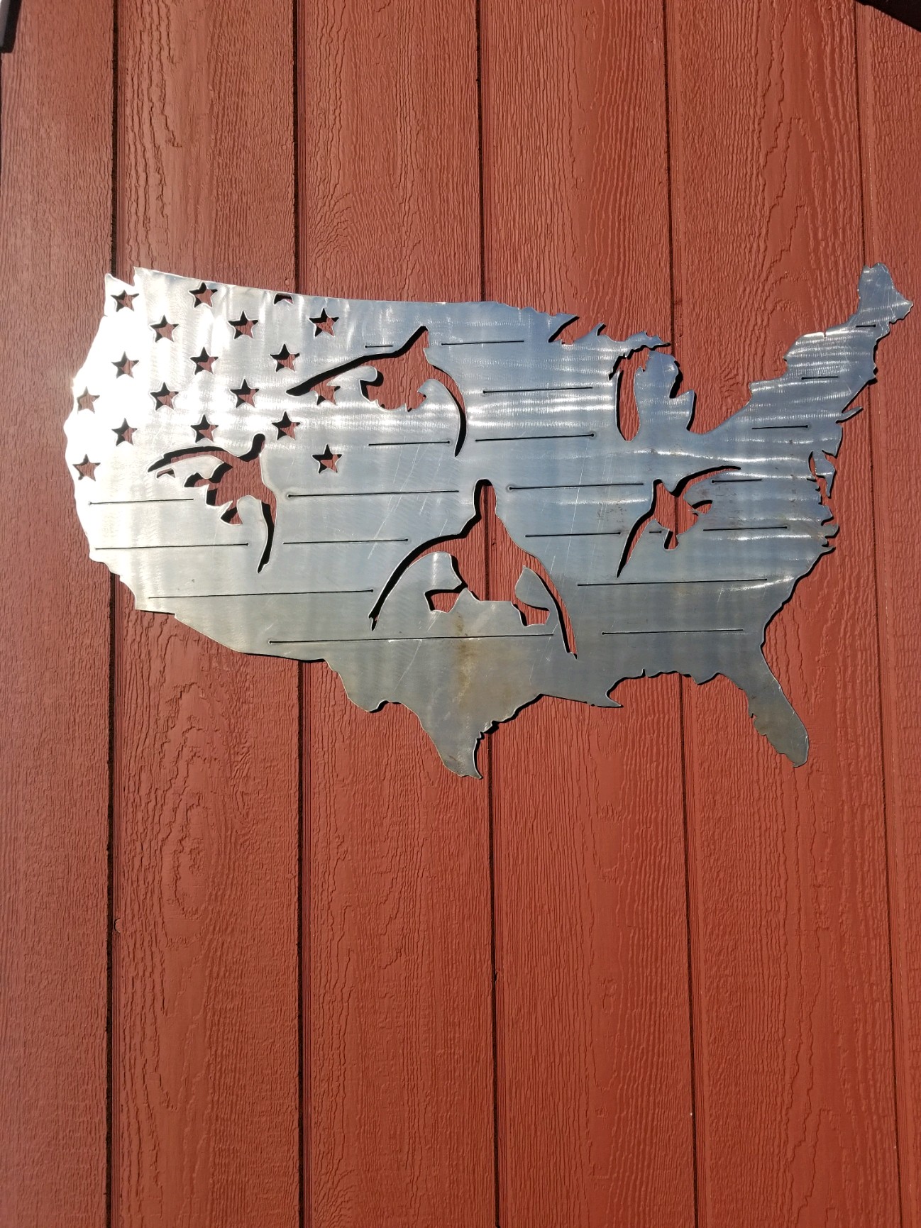 A USA-shaped metal design with flag and hunting details.