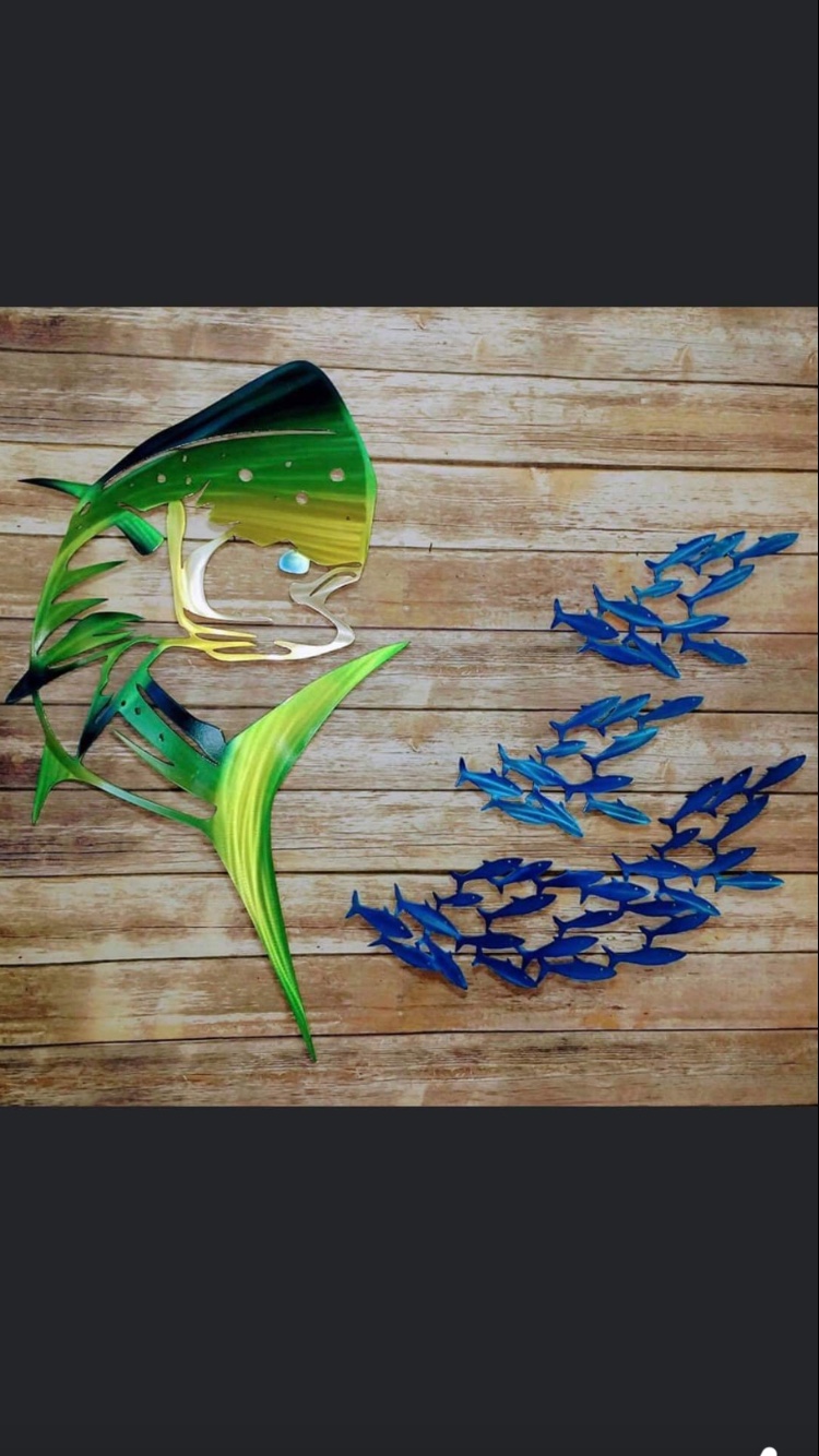 Colorful fish artwork displayed on a wood background.