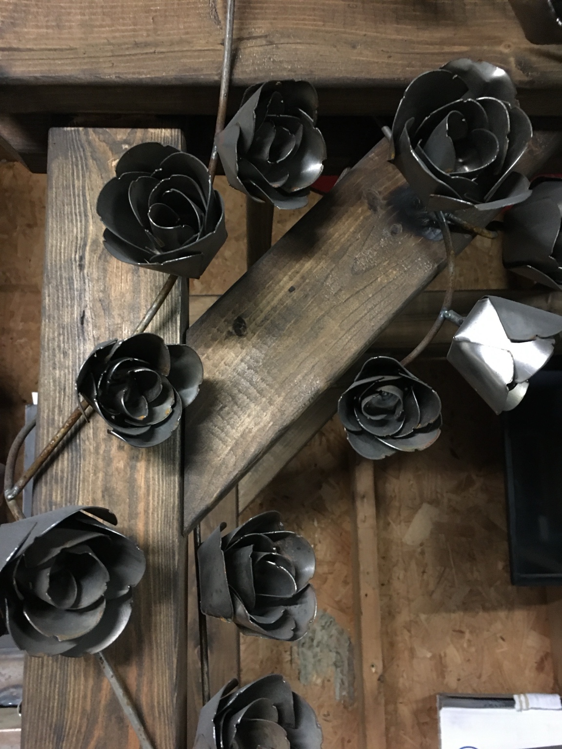 A collection of metal roses with formed petals and stems.