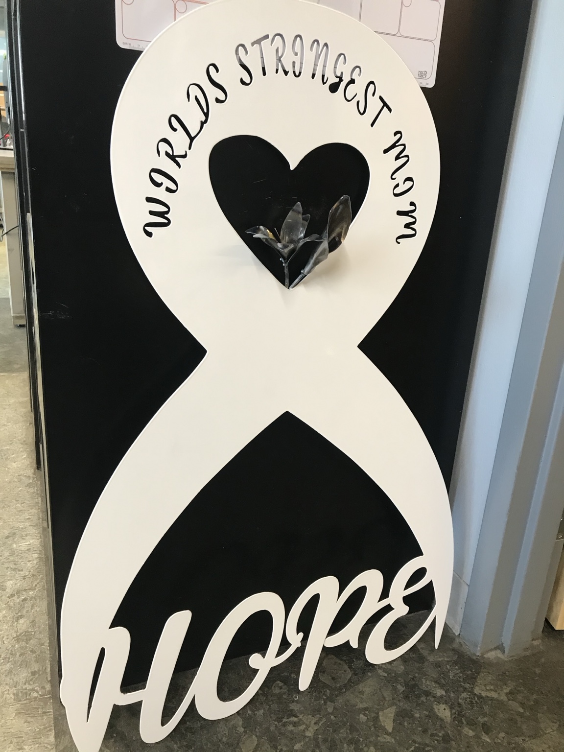 A personalized ribbon-shaped sign with a heart and Hope lettering.