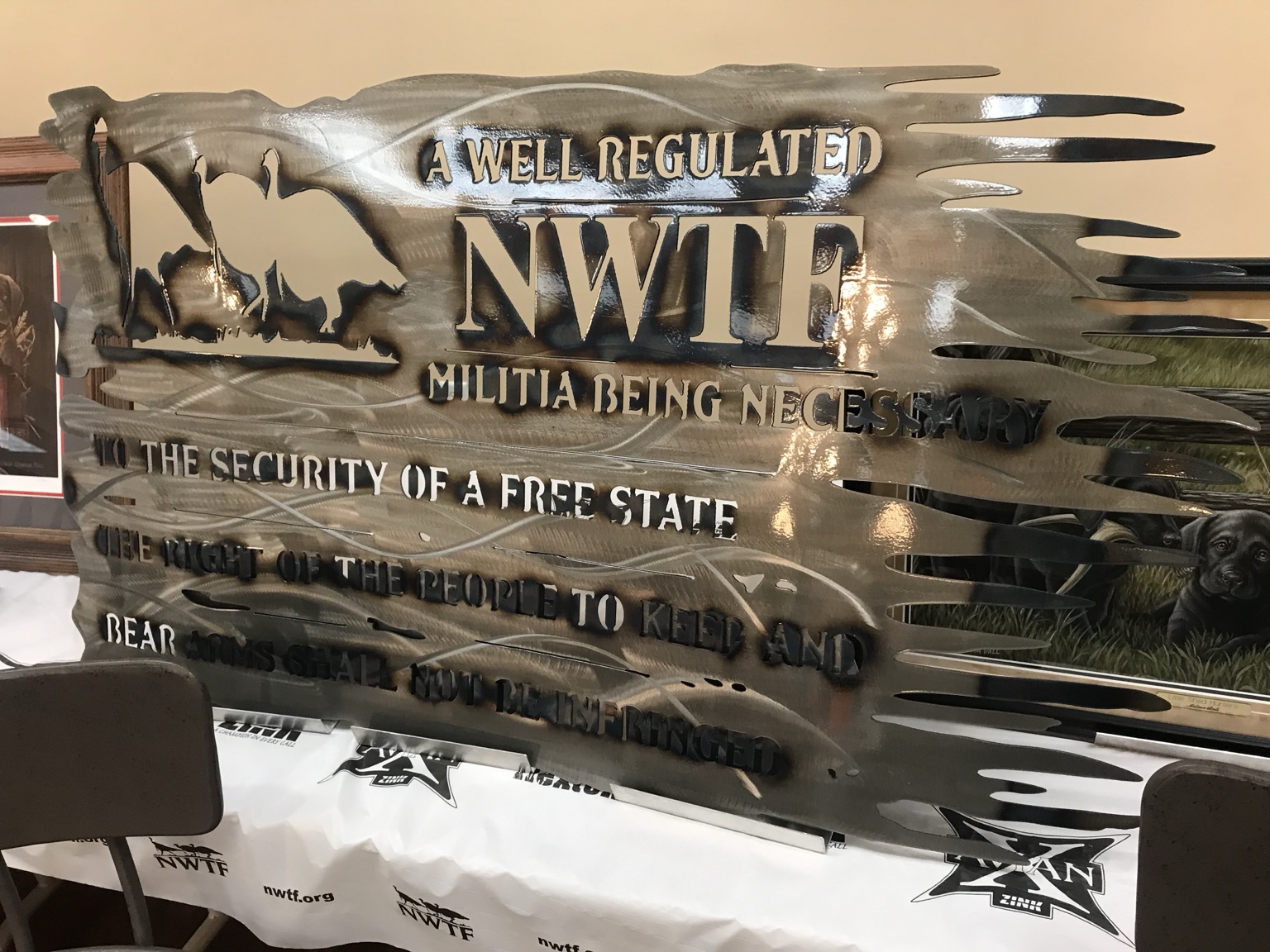 A metal display with NWTF lettering and turkey details.