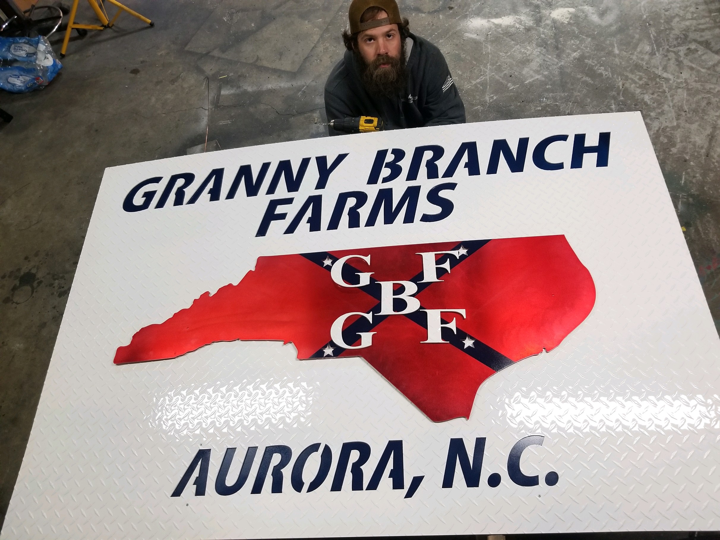 A painted sign with Granny Branch Farms lettering and a North Carolina design.